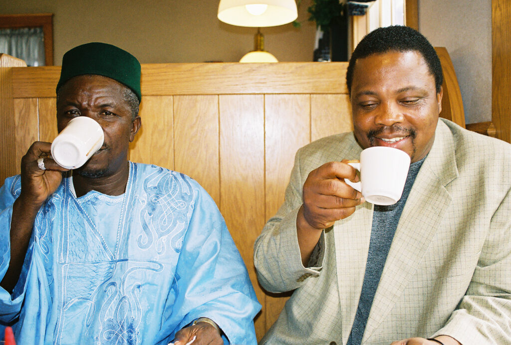 Chief Alie Badara Sheriff Drinks Coffee with Askia at a Medford, Wisconsin Cafe